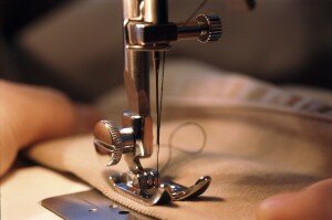 Close up of hands and sewing machine needle