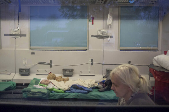 1Family members accompany evacuated Ukrainian disabled children by doctors of the Central Clinical Hospital (MSWIA) from Warsaw in a special train heading for Gdansk, near the border crossing in Medyka, Poland, Thursday, March 10, 2022. (AP Photo/Visar Kryeziu)